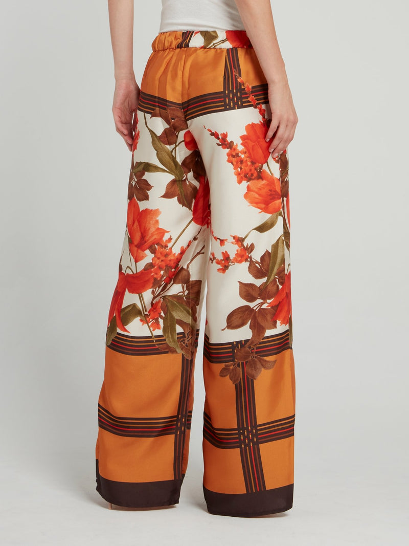 Оранжевые широкие брюки с цветочным принтом