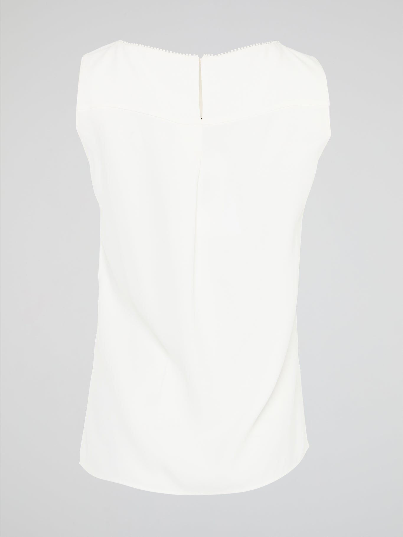 Introducing a timeless masterpiece for fashion-forward mavens - the White Sleeveless Top by Akris Punto. This ethereal beauty effortlessly combines sophistication and elegance with its minimalist design and impeccable tailoring. Crafted from luxurious fabrics, it's the perfect versatile piece to elevate your style, ensuring you're the epitome of chic from desk to dinner.