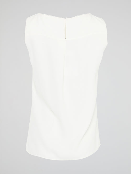 Introducing a timeless masterpiece for fashion-forward mavens - the White Sleeveless Top by Akris Punto. This ethereal beauty effortlessly combines sophistication and elegance with its minimalist design and impeccable tailoring. Crafted from luxurious fabrics, it's the perfect versatile piece to elevate your style, ensuring you're the epitome of chic from desk to dinner.