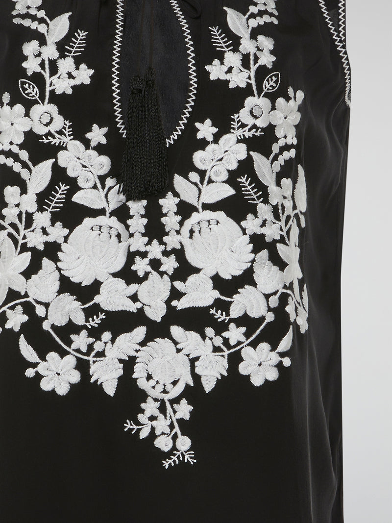 Step into a world of romantic charm with our mesmerizing Black Floral Embroidered Top by Parosh. Delicate blooms in rich hues beautifully cascade over the sheer fabric, creating a captivating visual play. This ethereal piece effortlessly blends sophistication with a hint of bohemian allure, making it a must-have for any fashion enthusiast.