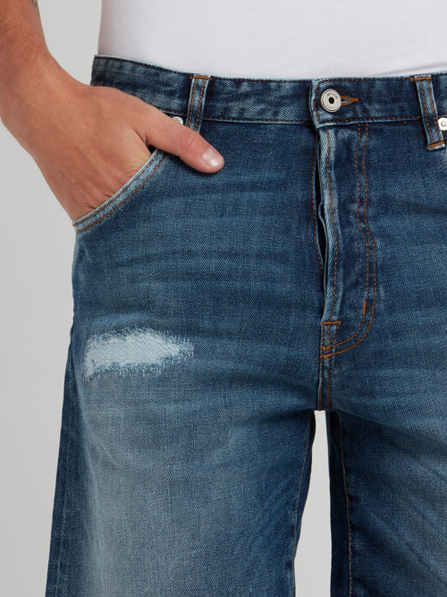Синие джинсовые шорты с рваной отделкой