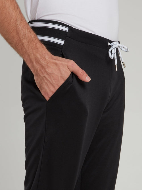 Черные спортивные брюки на резинке в полоску